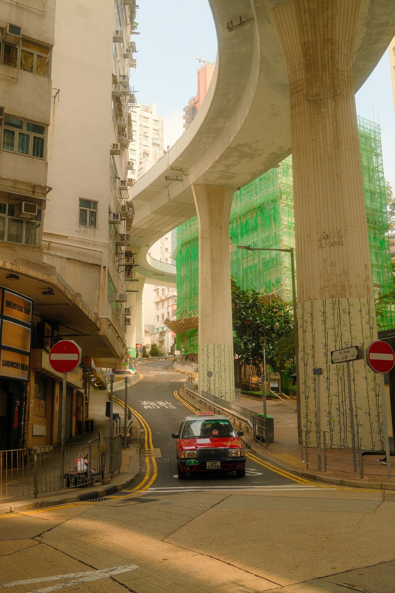 Curving overpass and red taxi in Hong Kong
