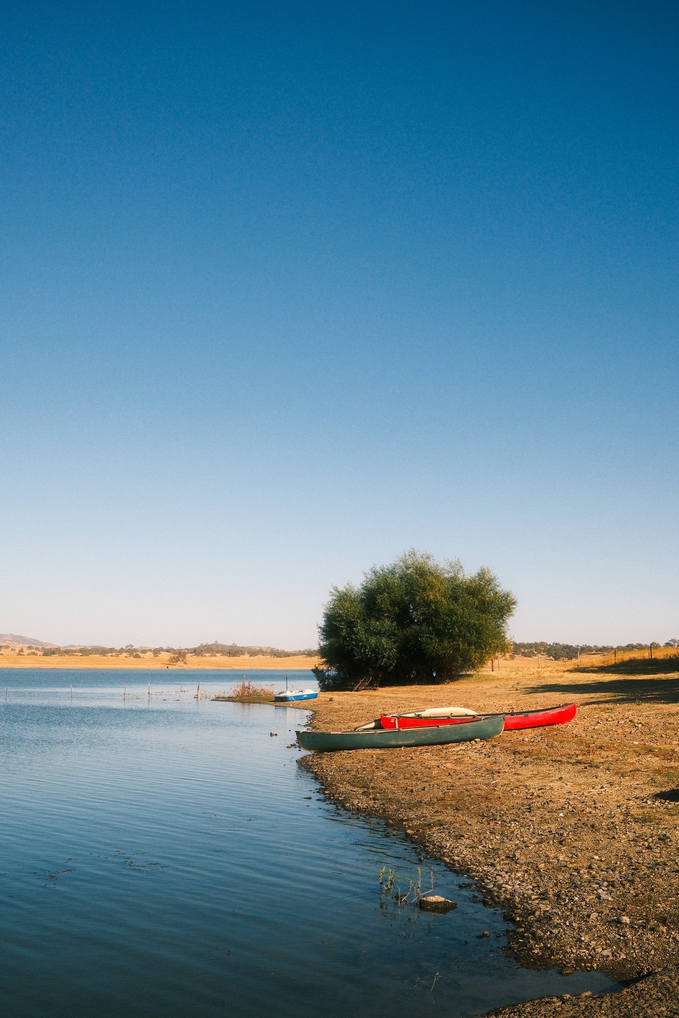 Red canoe on a lakeshore